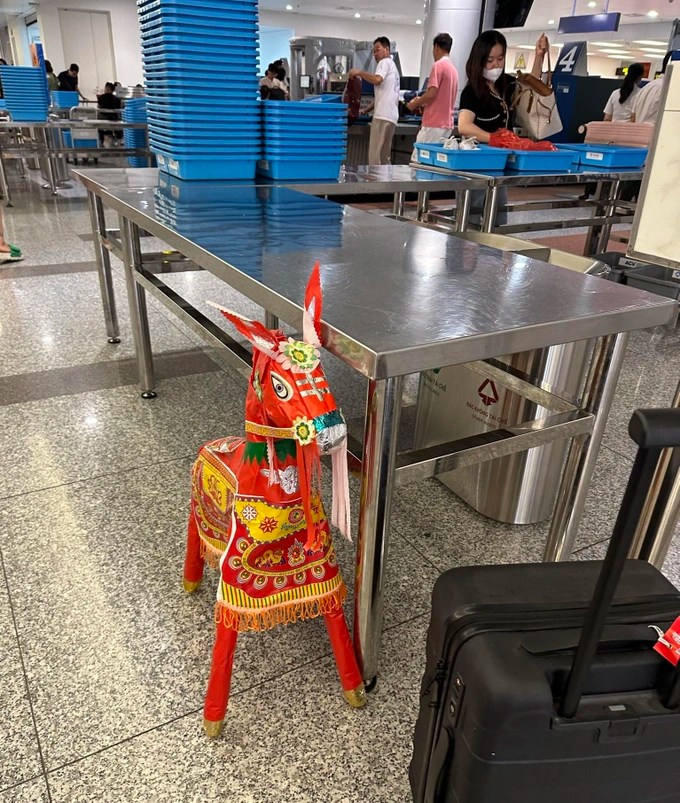 The paper horse made it through the check-in counter and security, but was refused to bring it on the plane