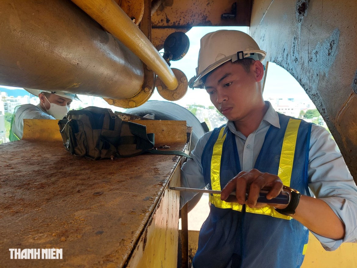 Engineers carefully inspect electrical cabinets