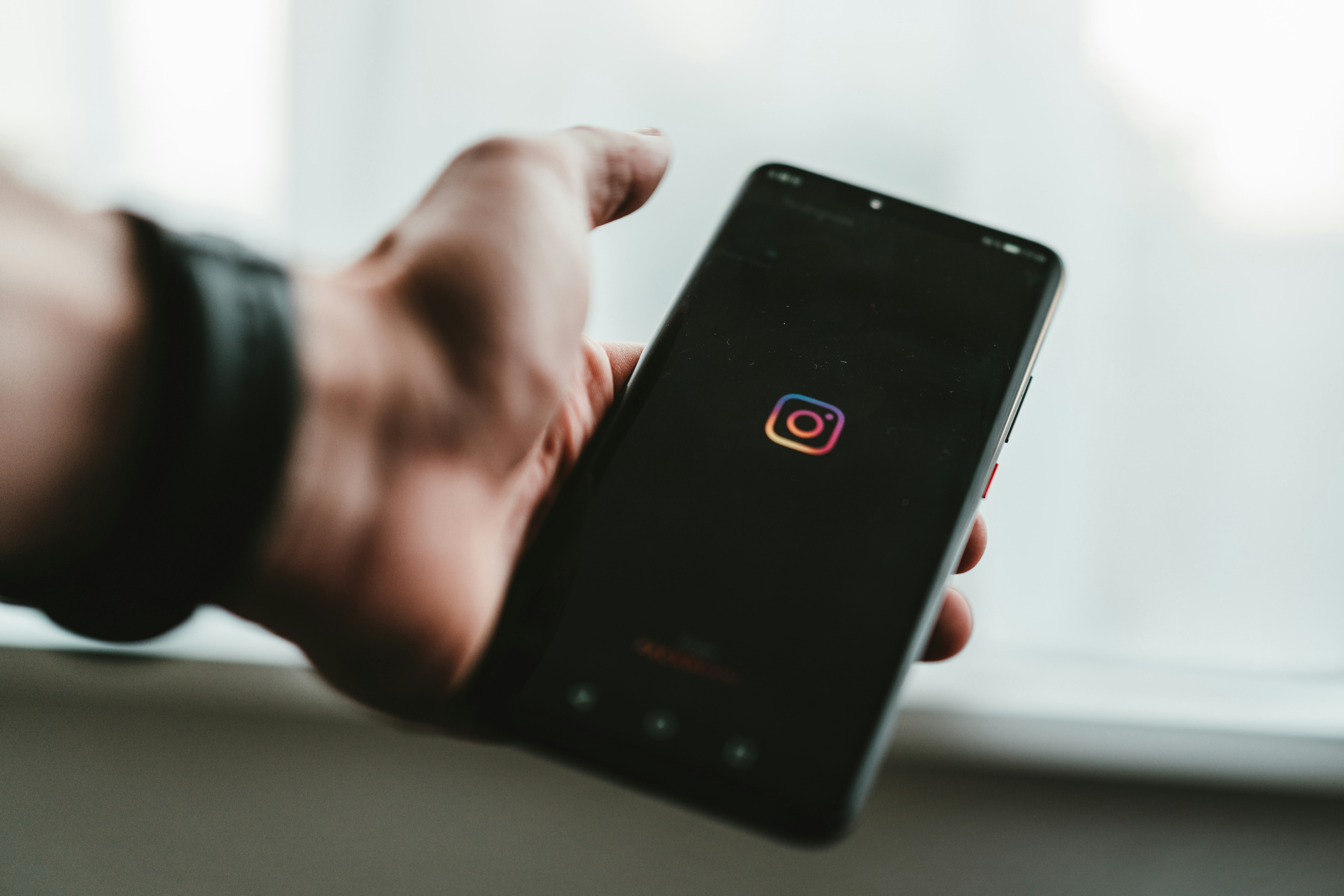 person holding black android smartphone with instagram app